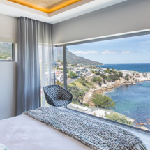 The main bedroom (bedroom 1) on the upper level is fit for royalty. A king size bed beckons you to lie back and soak in the elevated views of Bali Bay, the ocean and Twelve Apostles mountain range from floor to ceiling windows.
