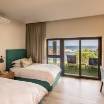 Bedroom 3, with its 2 generous ¾ beds is perfect for sharing and boasts access to the ground floor patio with its unmatched Atlantic Ocean views.